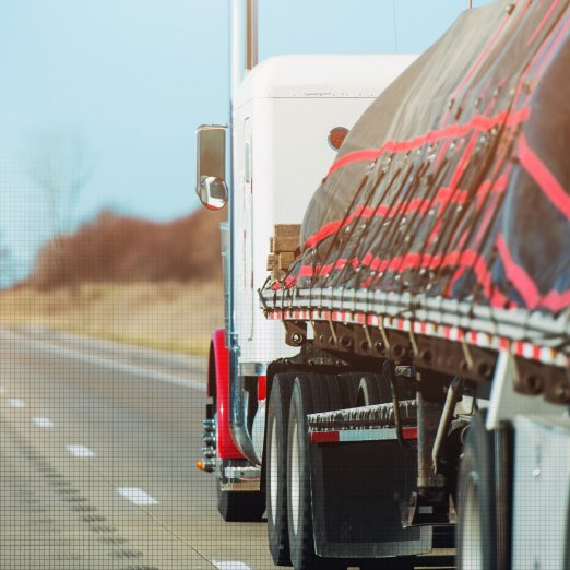 Commercial flatbed truck transporting heavy industrial process equipment to the Carolina PEC facility for engineered restoration.